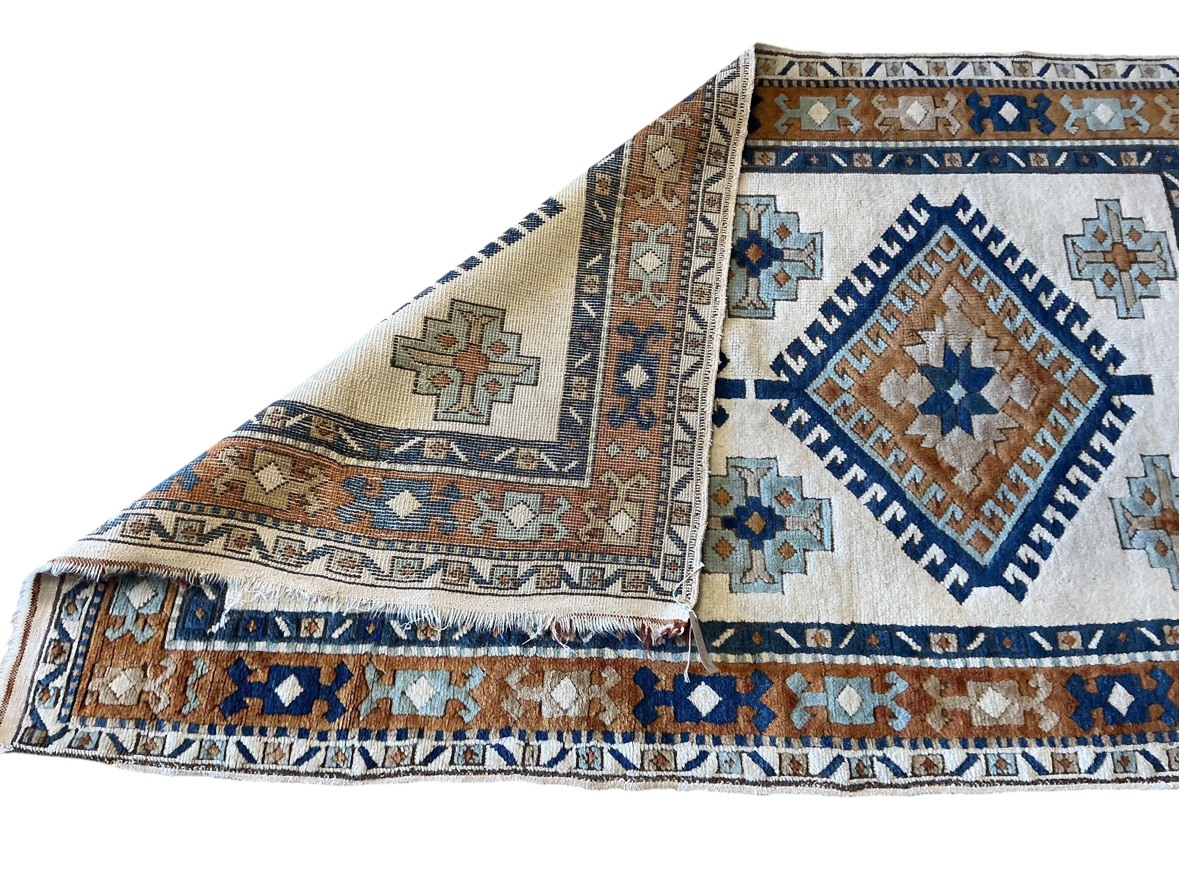 A Caucasian style ivory ground rug, 158 x 98cm